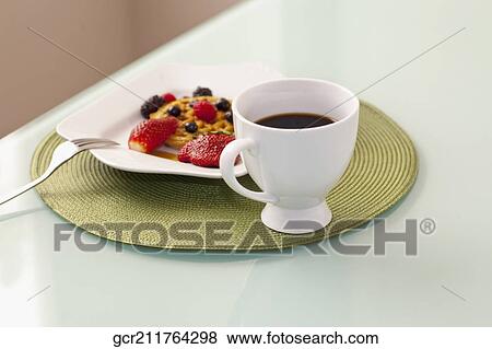 High angle view of strawberries with waffles and a cup of coffee View Large Photo Image Stock Photo - High angle view of strawberries with waffles and a cup of coffee. Fotosearch