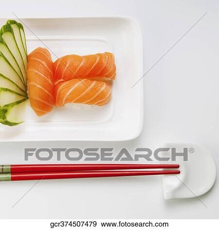 High angle view of sushi with chopsticks View Large Photo Image Stock Photo - High angle view of sushi with chopsticks. Fotosearch