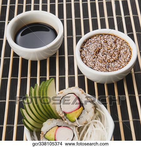Picture - High angle view of sushi with sesame seeds and soy sauce. Fotosearch