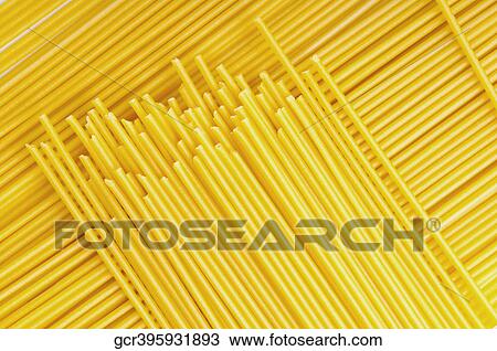 Stock Image - High angle view of uncooked spaghetti. Fotosearch