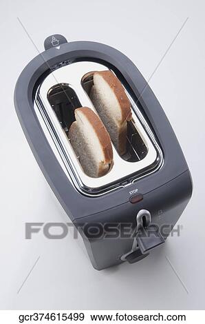 High angle view of white breads in a toaster View Large Photo Image Stock Photo - High angle view of white breads in a toaster. Fotosearch