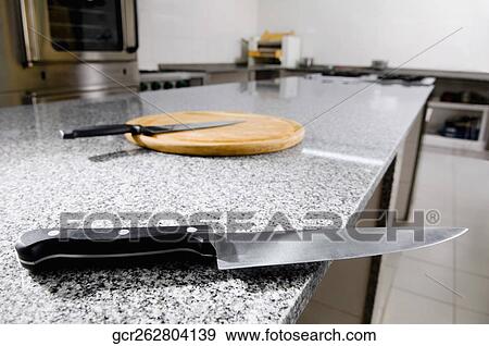 Kitchen knives with a cutting board View Large Photo Image Stock Photo - Kitchen knives with a cutting board. Fotosearch