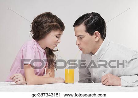 Man and his daughter drinking juice View Large Photo Image Stock Image - Man and his daughter drinking juice. Fotosearch
