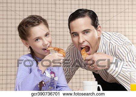 Man and his daughter eating breads View Large Photo Image Stock Image - Man and his daughter eating breads. Fotosearch