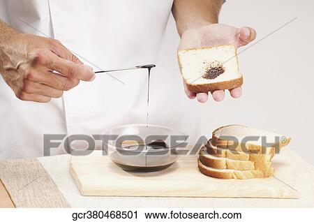 Man applying chocolate sauce on a slice of bread View Large Photo Image Stock Image - Man applying chocolate sauce on a slice of bread. Fotosearch