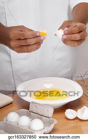 Man breaking eggs in a bowl View Large Photo Image Stock Image - Man breaking eggs in a bowl. Fotosearch
