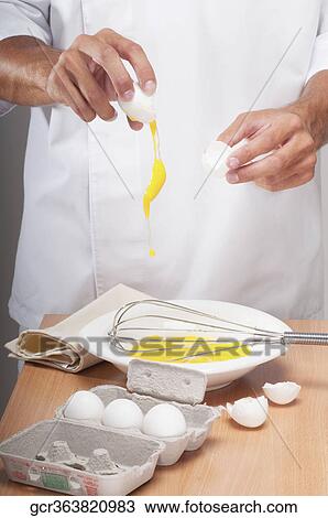 Man breaking eggs in a bowl View Large Photo Image Stock Image - Man breaking eggs in a bowl. Fotosearch