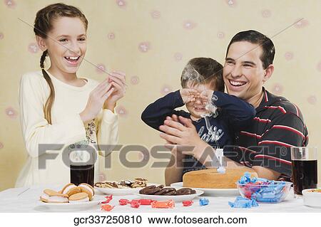 Man celebrating his son's birthday View Large Photo Image Stock Image - Man celebrating his son's birthday. Fotosearch