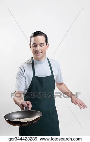 Stock Photo - Man cooking omelet. Fotosearch