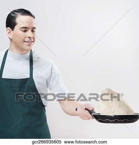 Man cooking omelet View Large Photo Image Stock Photography - Man cooking omelet. Fotosearch