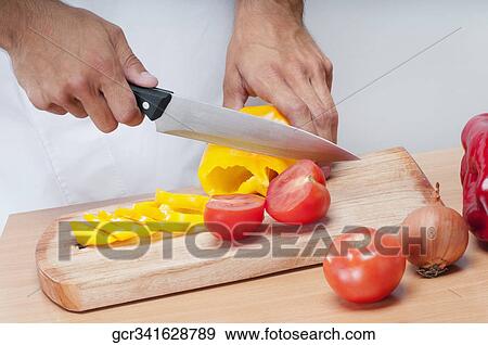 Man cutting a yellow bell pepper and tomatoes View Large Photo Image Stock Photo - Man cutting a yellow bell pepper and tomatoes. Fotosearch