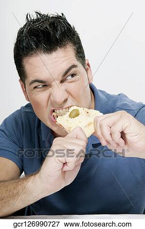 Man eating a slice of pizza View Large Photo Image Stock Photo - Man eating a slice of pizza. Fotosearch