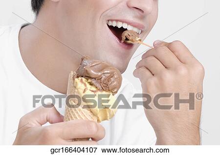 Man eating an ice cream View Large Photo Image Stock Photo - Man eating an ice cream. Fotosearch