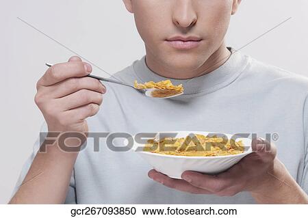 Man eating corn flakes View Large Photo Image Stock Image - Man eating corn flakes. Fotosearch