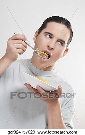 Man eating corn flakes View Large Photo Image Stock Image - Man eating corn flakes. Fotosearch