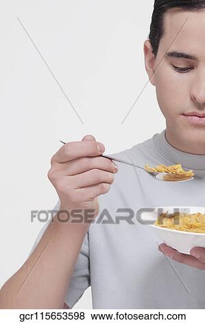Man eating corn flakes View Large Photo Image Stock Photo - Man eating corn flakes. Fotosearch