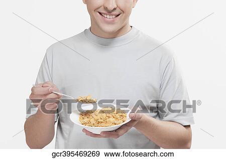 Man eating corn flakes View Large Photo Image Stock Photo - Man eating corn flakes. Fotosearch