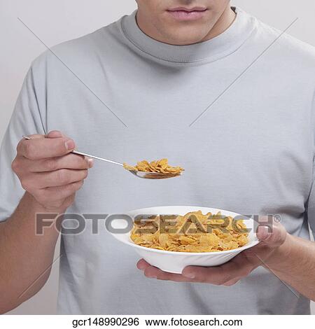Stock Photograph - Man eating corn flakes. Fotosearch