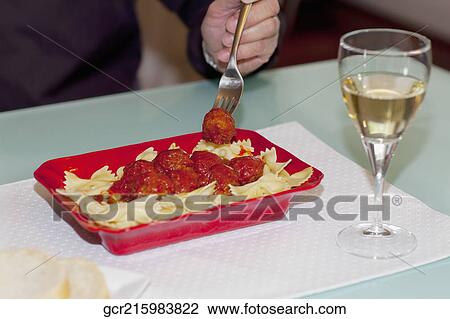 Man eating farfalle pasta and meatballs View Large Photo Image Stock Image - Man eating farfalle pasta and meatballs. Fotosearch