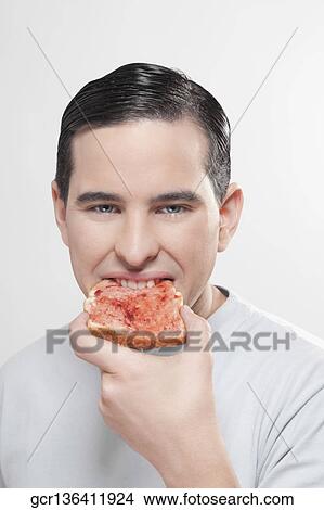 Man eating jam on toast View Large Photo Image Picture - Man eating jam on toast. Fotosearch