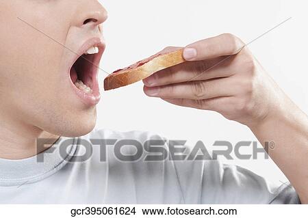 Man eating jam on toast View Large Photo Image Picture - Man eating jam on toast. Fotosearch