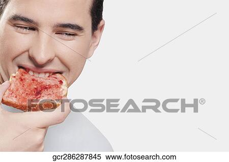 Man eating jam on toast View Large Photo Image Stock Photography - Man eating jam on toast. Fotosearch