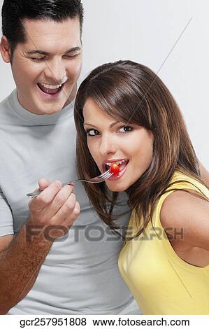 Man feeding cherry to a woman View Large Photo Image Stock Photo - Man feeding cherry to a woman. Fotosearch