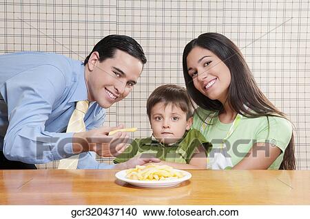 Man feeding French fries to his son View Large Photo Image Stock Image - Man feeding French fries to his son. Fotosearch