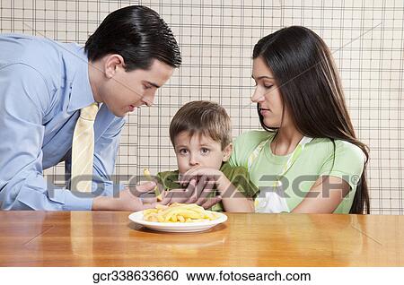 Man feeding French fries to his son View Large Photo Image Stock Image - Man feeding French fries to his son. Fotosearch