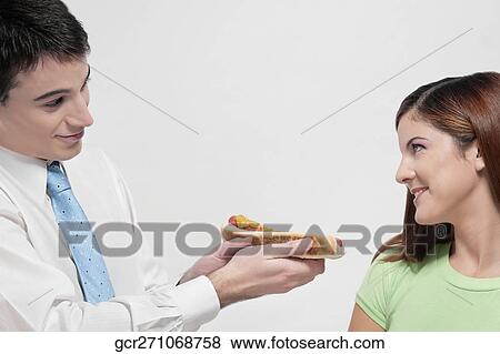 Man giving a hot dog to his wife View Large Photo Image Stock Photo - Man giving a hot dog to his wife. Fotosearch