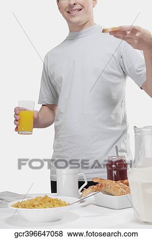 Stock Photo - Man having breakfast. Fotosearch