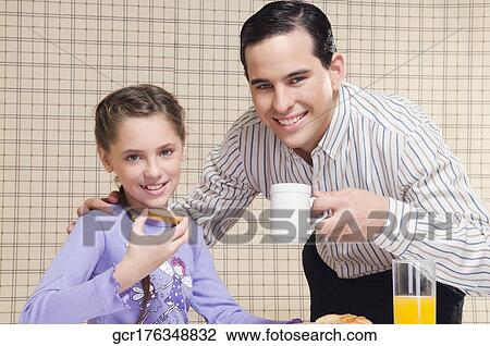 Man having breakfast with his daughter View Large Photo Image Stock Image - Man having breakfast with his daughter. Fotosearch