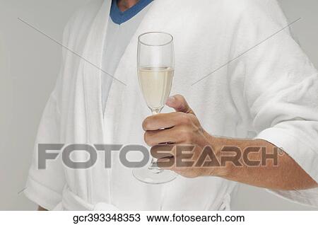 Man holding a champagne flute View Large Photo Image Stock Image - Man holding a champagne flute. Fotosearch