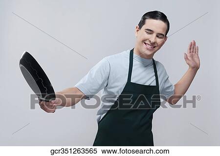 Man holding a frying pan View Large Photo Image Stock Photography - Man holding a frying pan. Fotosearch