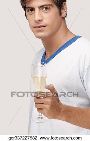Man holding a glass of champagne View Large Photo Image Stock Image - Man holding a glass of champagne. Fotosearch