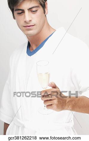 Stock Photo - Man holding a glass of champagne. Fotosearch