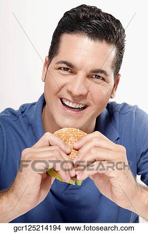 Picture - Man holding a hamburger. Fotosearch