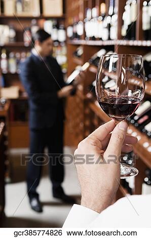 Man holding a wine glass View Large Photo Image Stock Photograph - Man holding a wine glass. Fotosearch