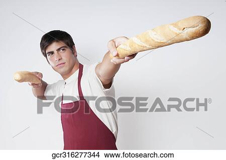 Man holding baguettes in both hands View Large Photo Image Picture - Man holding baguettes in both hands. Fotosearch