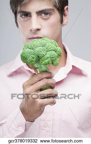 Man holding broccoli and thinking View Large Photo Image Stock Image - Man holding broccoli and thinking. Fotosearch