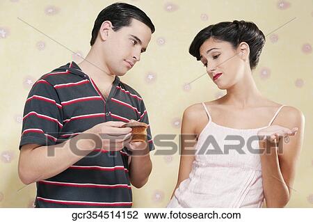 Stock Image - Man showing a burnt toast to a woman. Fotosearch