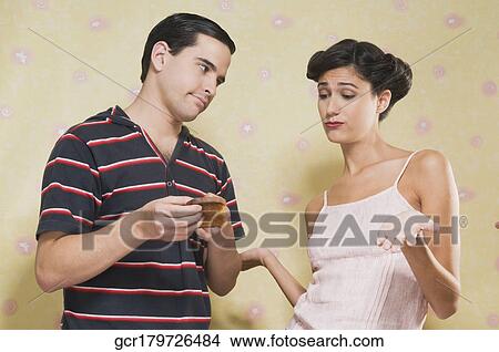 Man showing his wife a burnt toast View Large Photo Image Picture - Man showing his wife a burnt toast. Fotosearch