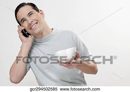 Man talking on a mobile phone and smiling View Large Photo Image Stock Photography - Man talking on a mobile phone and smiling. Fotosearch
