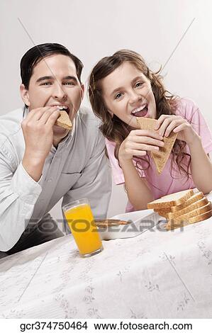 Man with his daughter at a breakfast table View Large Photo Image Picture - Man with his daughter at a breakfast table. Fotosearch