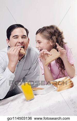 Man with his daughter having breakfast View Large Photo Image Stock Photograph - Man with his daughter having breakfast. Fotosearch