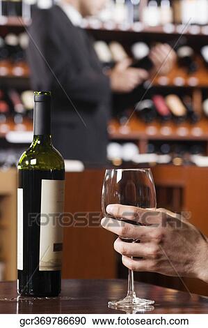 Man's hand holding a wine glass View Large Photo Image Stock Image - Man's hand holding a wine glass. Fotosearch