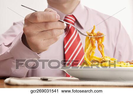 Mid section view of a businessman having lunch View Large Photo Image Stock Image - Mid section view of a businessman having lunch. Fotosearch