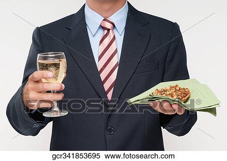 Mid section view of a businessman holding a glass of wine and a tart View Large Photo Image Stock Photography - Mid section view of a businessman holding a glass of wine and a tart. Fotosearch