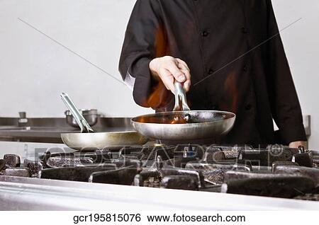Mid section view of a chef cooking food View Large Photo Image Stock Photograph - Mid section view of a chef cooking food. Fotosearch