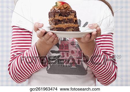 Mid section view of a girl holding a plate of chocolate pastry View Large Photo Image Picture - Mid section view of a girl holding a plate of chocolate pastry. Fotosearch